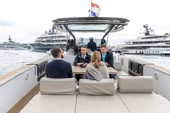 Johnny (right) gives his clients the lowdown on the Burgess charter fleet