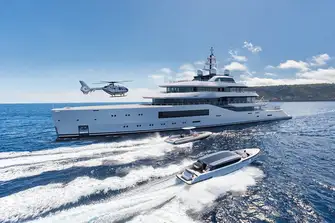 Two tenders stow behind shell doors on the main deck forward, below the touch-and-go helipad