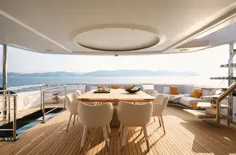 Open air dining with bar and wine fridge on hand makes a perfect entertainment space