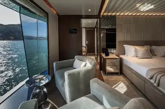 The full-beam master suite has a lounge next to a full-height window, a blissful place to start the day