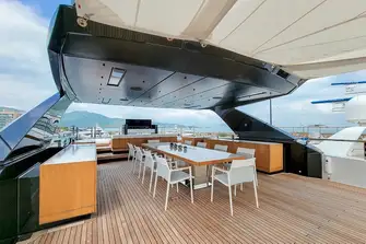 Sun deck dining beneath the hardtop, with extensive sun lounging space aft