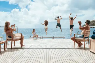 With the transom folded down and the tenders launched, the garage becomes a beach club