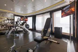 The fully equipped gym overlooks the helipad, which also serves as sun lounge and entertainment space