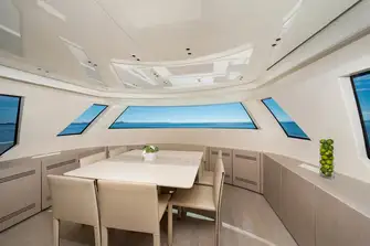 Forward on the main deck is a family galley and a formal dining room with wraparound views