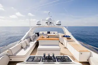 Looking aft from the flybridge across the open-air dining to the sun lounge