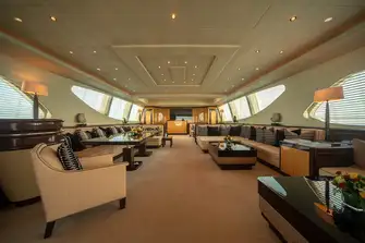 Looking forward in the main saloon, from the lounge and bar area to daybeds beneath skylights forward