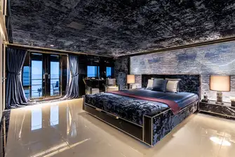 The main deck owner's suite is full beam and features folding balconies either side