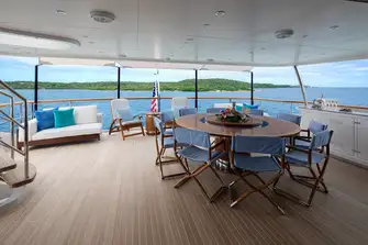 Open-air dining and sun lounging on the bridge deck aft