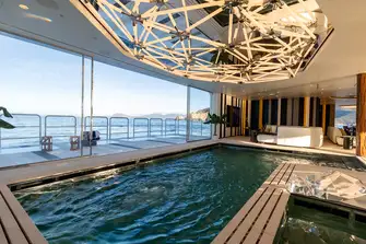 A 50sqm sea terrace outside a 30sqm counter flow pool, with a bottom that rises to become a dancefloor
