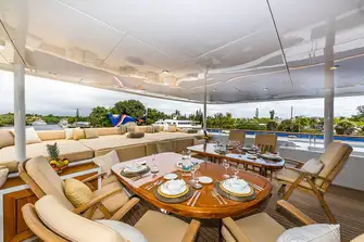 Open air dining and sun lounging on the bridge deck aft