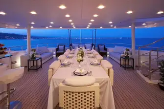 Open-air dining and a bar on the bridge deck aft