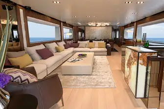 Full-height sliding glass doors open into the main saloon