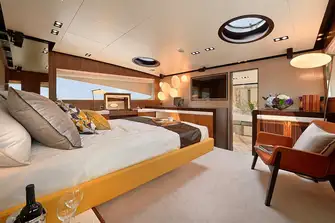 The split-level owner's suite with steps into the bathroom forward