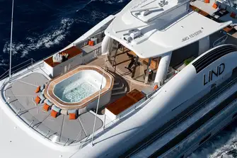 Sunpads, jacuzzi and a gym with sliding glass doors forward