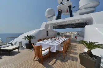 Looking forward on the sun deck across dining, bar and BBQ to the raised lounge area