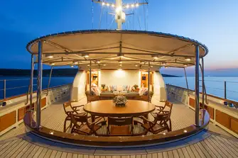Open-air dining and lounging on the main deck aft
