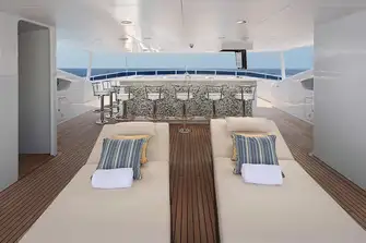 SUNONE - Looking forward beneath the sun deck's hardtop towards the large sit-up bar