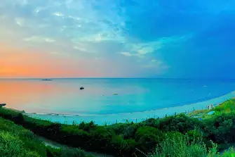 The sun rises over Salins Beach